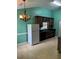 The eat-in kitchen features ample cabinetry, a black countertop, linoleum flooring, and modern lighting at 10111 Commons Way, Jonesboro, GA 30238
