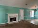 The cozy living room has a fireplace, carpeted floors, a door to the exterior, and a neutral color palette at 10111 Commons Way, Jonesboro, GA 30238