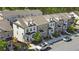 Aerial view of townhomes with brick and siding exteriors, dormer windows, and manicured yards in an attractive community at 1329 Bennett Creek Ovlk, Suwanee, GA 30024