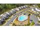 Aerial view featuring a neighborhood pool, clubhouse, and playground nestled among modern homes and green spaces at 1329 Bennett Creek Ovlk, Suwanee, GA 30024