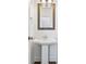 Small half bathroom with pedestal sink, mirror and lighting at 1329 Bennett Creek Ovlk, Suwanee, GA 30024