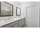 Clean bathroom with double sinks, quartz countertops, framed mirrors, and neutral tile flooring at 1329 Bennett Creek Ovlk, Suwanee, GA 30024