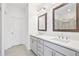 Well-lit bathroom with double sinks, quartz countertops, framed mirrors, and a glass-enclosed shower at 1329 Bennett Creek Ovlk, Suwanee, GA 30024