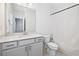 Bright bathroom featuring a white vanity with marble countertop, modern fixtures, toilet, and a shower tub with a curtain at 1329 Bennett Creek Ovlk, Suwanee, GA 30024