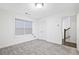 Spacious bedroom with neutral carpet, ample natural light from a large window, and easy access to other rooms at 1329 Bennett Creek Ovlk, Suwanee, GA 30024