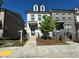 Well-maintained brick and painted brick townhome with mature landscaping at 1329 Bennett Creek Ovlk, Suwanee, GA 30024