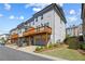 Three-story townhouse features wood decks, neutral color scheme, basement garage, and manicured landscaping at 1329 Bennett Creek Ovlk, Suwanee, GA 30024