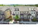 Charming townhomes with brick and siding exteriors, dormer windows, and manicured front yards create a welcoming curb appeal at 1329 Bennett Creek Ovlk, Suwanee, GA 30024