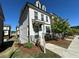 Beautiful brick and painted brick townhome with landscaping and a sidewalk at 1329 Bennett Creek Ovlk, Suwanee, GA 30024