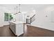 Bright kitchen features an island with white countertop, stainless steel sink, and pendant lighting at 1329 Bennett Creek Ovlk, Suwanee, GA 30024
