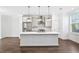 Modern kitchen with a large island, stainless steel appliances, and pendant lights at 1329 Bennett Creek Ovlk, Suwanee, GA 30024