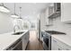 Modern kitchen with stainless steel appliances, white cabinets, and sleek countertops at 1329 Bennett Creek Ovlk, Suwanee, GA 30024