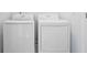 Well-lit laundry room featuring a modern, white washer and dryer set for convenient home chores at 1329 Bennett Creek Ovlk, Suwanee, GA 30024