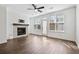 Well lit living room features hardwood floors, a ceiling fan, a decorative fireplace at 1329 Bennett Creek Ovlk, Suwanee, GA 30024