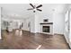 Open concept living area with fireplace, hardwood floors, ceiling fan, island, staircase at 1329 Bennett Creek Ovlk, Suwanee, GA 30024