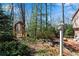 Wooded backyard garden with an arbor, stream, and deck at 1548 Valley Reserve Nw Ct, Kennesaw, GA 30152