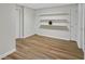 Finished basement area featuring new laminate flooring and white shelving, offering flexibility at 1548 Valley Reserve Nw Ct, Kennesaw, GA 30152