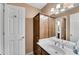 Well lit bathroom featuring white countertop, wood cabinets, and mirrored storage at 1548 Valley Reserve Nw Ct, Kennesaw, GA 30152