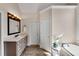 Elegant bathroom featuring soaking tub with tile surround and spacious vanity at 1548 Valley Reserve Nw Ct, Kennesaw, GA 30152