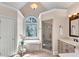 Bright primary bathroom with garden tub, stained glass, shower and vanity at 1548 Valley Reserve Nw Ct, Kennesaw, GA 30152