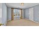 Bedroom with neutral carpet, light blue walls, and window with wood shutters at 1548 Valley Reserve Nw Ct, Kennesaw, GA 30152
