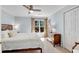 Bright bedroom featuring a ceiling fan, soft carpet, and large windows with nature views at 1548 Valley Reserve Nw Ct, Kennesaw, GA 30152