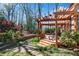 Wooden deck and pergola with stone paver patio and wooded backdrop at 1548 Valley Reserve Nw Ct, Kennesaw, GA 30152