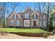 Charming brick home with manicured lawn and beautiful stone retaining wall at 1548 Valley Reserve Nw Ct, Kennesaw, GA 30152