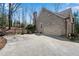 Spacious garage and driveway with stone and iron gate and a well-maintained brick exterior at 1548 Valley Reserve Nw Ct, Kennesaw, GA 30152