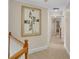 Upstairs hallway with neutral carpet and wall color with art display at 1548 Valley Reserve Nw Ct, Kennesaw, GA 30152