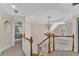 Upstairs hallway with elegant staircase, chandelier and view into other rooms at 1548 Valley Reserve Nw Ct, Kennesaw, GA 30152
