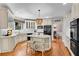 Stylish white kitchen with an island, bar stool seating, and stainless steel appliances at 1548 Valley Reserve Nw Ct, Kennesaw, GA 30152