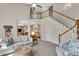 Comfortable living room with staircase access, fireplace, and plush seating at 1548 Valley Reserve Nw Ct, Kennesaw, GA 30152