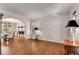 Open living room with hardwood floors, archway, and natural light through shuttered windows at 1548 Valley Reserve Nw Ct, Kennesaw, GA 30152