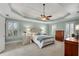 Spacious primary bedroom featuring tray ceiling, fan, and two bright windows at 1548 Valley Reserve Nw Ct, Kennesaw, GA 30152