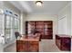 Well-lit office with custom built-in bookshelves and sleek contemporary desk at 1548 Valley Reserve Nw Ct, Kennesaw, GA 30152