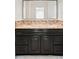 Bathroom showcasing a dual-sink vanity with dark cabinetry and a large framed mirror at 2895 Dunnington Cir, Atlanta, GA 30341