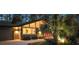 Inviting home exterior featuring a modern design, warm lighting, and vibrant landscaping at twilight at 2895 Dunnington Cir, Atlanta, GA 30341