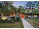 Eye-catching single-story home featuring a stone facade, blue siding, manicured lawn, and vibrant orange front door at 2895 Dunnington Cir, Atlanta, GA 30341
