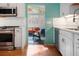 Stylish kitchen with white cabinets, stainless steel appliances and adjacent cozy living area at 2895 Dunnington Cir, Atlanta, GA 30341