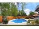 Beautiful in-ground pool surrounded by a wood fence and lush trees at 2895 Dunnington Cir, Atlanta, GA 30341