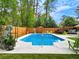 Beautiful in-ground pool surrounded by a wood fence and lush trees at 2895 Dunnington Cir, Atlanta, GA 30341