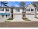 Charming townhome exterior featuring brick accents, painted siding, and attached garages at 429 Brooch Way, Stockbridge, GA 30281
