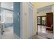 Hall view leading to a bathroom with a bright window and white fixtures at 462 N Highland Ave, Atlanta, GA 30307