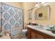 Cozy bathroom with decorative shower curtain, single sink vanity, and vintage fixtures at 462 N Highland Ave, Atlanta, GA 30307