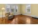 Bright bedroom with hardwood floors, windows with shutters, and vintage armchair at 462 N Highland Ave, Atlanta, GA 30307