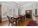 Elegant dining room with hardwood floors, a fireplace, and a large window providing natural light at 462 N Highland Ave, Atlanta, GA 30307