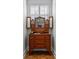Traditional wood dresser with tri-fold mirror in a nook with window and wood floors at 462 N Highland Ave, Atlanta, GA 30307