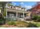 A beautifully designed house with a welcoming front porch and lush green lawn at 462 N Highland Ave, Atlanta, GA 30307