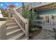 Charming exterior with a stairway leading to the front porch, showing landscaped garden at 462 N Highland Ave, Atlanta, GA 30307